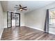 Spacious basement room with glass doors and ceiling fan at 490 Revenna Trl, Fayetteville, GA 30214