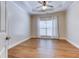 Well-lit bedroom featuring hardwood floors and large window at 490 Revenna Trl, Fayetteville, GA 30214