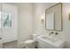 Stylish powder room with floating vanity and gold accents at 114 Terrace Ne Dr, Atlanta, GA 30305