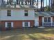 Ranch style home with brick and white siding, green roof, and small front yard at 3068 Hillwood Dr, Lawrenceville, GA 30044