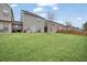 Spacious backyard with grassy area and townhomes at 3135 Hendrick Dr, Mcdonough, GA 30253