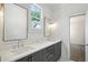 Modern bathroom with double vanity, marble countertops, and elegant gray cabinets at 116 Terrace Dr, Atlanta, GA 30305