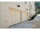 Two-car garage with light beige doors and exterior lighting at 116 Terrace Dr, Atlanta, GA 30305