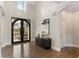 Bright foyer with hardwood floors, double doors, and a modern console table at 2753 Pinebloom Way, Duluth, GA 30097