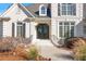 Elegant front entrance with black wrought iron doors and white brick steps at 2753 Pinebloom Way, Duluth, GA 30097