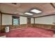 Spacious finished basement room with red carpet and wood paneling at 2979 Kelly Ct, Lawrenceville, GA 30044