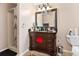 Bathroom with dark brown vanity, granite countertop, and shower/tub combo at 942 Maple Leaf Rdg, Jonesboro, GA 30238