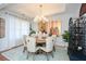 Elegant dining room features a wood table, chandelier, and stylish seating at 405 Laurel Spring Ct, Canton, GA 30114