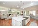 Open concept kitchen with large island, hardwood floors, and views to living room at 405 Laurel Spring Ct, Canton, GA 30114