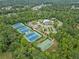 Aerial view of community amenities, including tennis courts, a pool, and a clubhouse at 6615 Grove Meadows Ln, Cumming, GA 30028