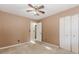 Well-lit bedroom with ceiling fan and closet at 84 Jousters Ln, Lawrenceville, GA 30044