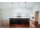 Modern kitchen featuring a large island and hardwood floors at 101 Forsyth Park Ln, Woodstock, GA 30188