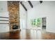 Bright living room featuring a large stone fireplace and hardwood floors at 101 Forsyth Park Ln, Woodstock, GA 30188