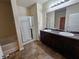 Bathroom with double vanity, shower, and bathtub at 1580 Culpepper Ln, Mcdonough, GA 30253