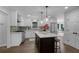 Bright kitchen boasts white cabinets, stainless steel appliances & an island at 1755 Durrett Cv, Atlanta, GA 30338