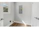 Bright laundry room with wood flooring and a window at 6684 Birch Road Rd, Winston, GA 30187