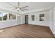 Sunroom with wood-look flooring, multiple windows, and a ceiling fan at 6684 Birch Rd, Winston, GA 30187