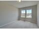 Bright bedroom with neutral carpeting and two windows at 11974 Brightside Pkwy, Hampton, GA 30228