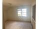 Simple bedroom with carpeted floors and a window at 4382 Oakleaf Cv, Decatur, GA 30034