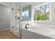 Spa-like bathroom with soaking tub, walk-in shower, and herringbone tile at 1139 Hembree Ln, Austell, GA 30168