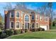 Brick house with a two-car garage and manicured lawn at 310 Melissa Way, Atlanta, GA 30349