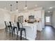 Modern kitchen with white cabinetry, island with seating, and stainless steel appliances at 3309 Cranston Ln, Kennesaw, GA 30144