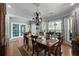 Formal dining room with hardwood floors, large windows, and a beautiful chandelier at 1561 Aiken Chafin Ln, Mcdonough, GA 30252