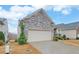 House exterior with stone facade and landscaping at 5860 Collier Bridge Ln, Hoschton, GA 30548