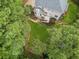 Aerial view of house nestled in wooded lot at 25 Grange Ct, Sharpsburg, GA 30277