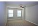 Bright bedroom featuring two windows and ceiling fan at 787 Belrose Dr, Smyrna, GA 30080