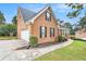 Brick home with a two-car garage and manicured lawn at 2213 Jessowen Se Way, Conyers, GA 30013