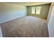 Spacious bedroom with neutral carpeting and large windows at 2422 Brown Dove Way, Grayson, GA 30017