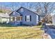 Gray house with a front porch and landscaped yard at 2506 Maple St, East Point, GA 30344