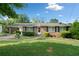 Brick ranch house with carport, landscaped lawn, and mature trees at 181 Edwards St, Canton, GA 30114