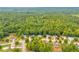 Aerial view of houses in a wooded neighborhood at 1216 Bradford Park Ln, Auburn, GA 30011