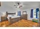 Main bedroom with king-size bed and ceiling fan at 1216 Bradford Park Ln, Auburn, GA 30011