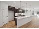 Modern kitchen with dark cabinets, white countertops, and an island at 1612 Tide Mill Rd, Cumming, GA 30040