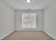 Well-lit bedroom featuring neutral walls and carpet flooring at 381 Paper Woods Dr, Lawrenceville, GA 30046