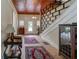 Bright and spacious entryway with hardwood floors, staircase, and antique furniture at 788 S Hwy 11 S, Social Circle, GA 30025