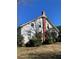 Side view of a white farmhouse with a brick chimney and mature landscaping at 788 S Hwy 11 S, Social Circle, GA 30025