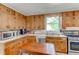 Galley kitchen with wood cabinets and appliances at 788 S Hwy 11 S, Social Circle, GA 30025