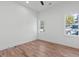 Well-lit bedroom with hardwood floors and two windows at 156 Martha Ne Ave, Atlanta, GA 30317