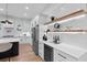 Modern kitchen with white cabinets, wine cooler, and floating shelves at 156 Martha Ne Ave, Atlanta, GA 30317