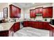 Kitchen with granite countertops and rich wood cabinetry at 25 Inverleigh Row, Covington, GA 30014