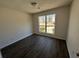 Bright bedroom with large window and dark brown laminate flooring at 4761 Klondike Cv, Lithonia, GA 30038