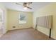Bedroom with ceiling fan, window, and neutral carpet at 1051 Rock Springs Rd, Lawrenceville, GA 30043