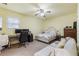 Bright bedroom with a desk, bed, and ceiling fan at 1051 Rock Springs Rd, Lawrenceville, GA 30043