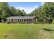 Brick ranch house with a large yard and mature trees at 1051 Rock Springs Rd, Lawrenceville, GA 30043
