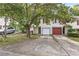 Front view of townhome with driveway and landscaping at 3008 Pine Tree Trl # 16D, South Fulton, GA 30349