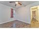 Hardwood floor bedroom with ceiling fan and access to hallway at 3150 Humphries Se Dr, Atlanta, GA 30354